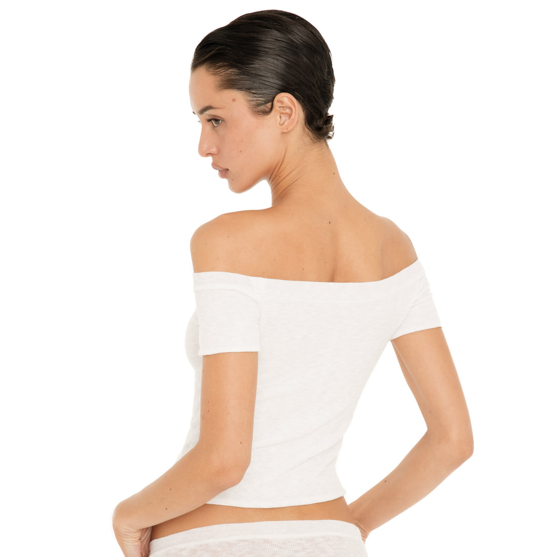 Back view of the white Solei off-the-shoulder top, showing the fitted shape and wide neckline across the shoulders **white