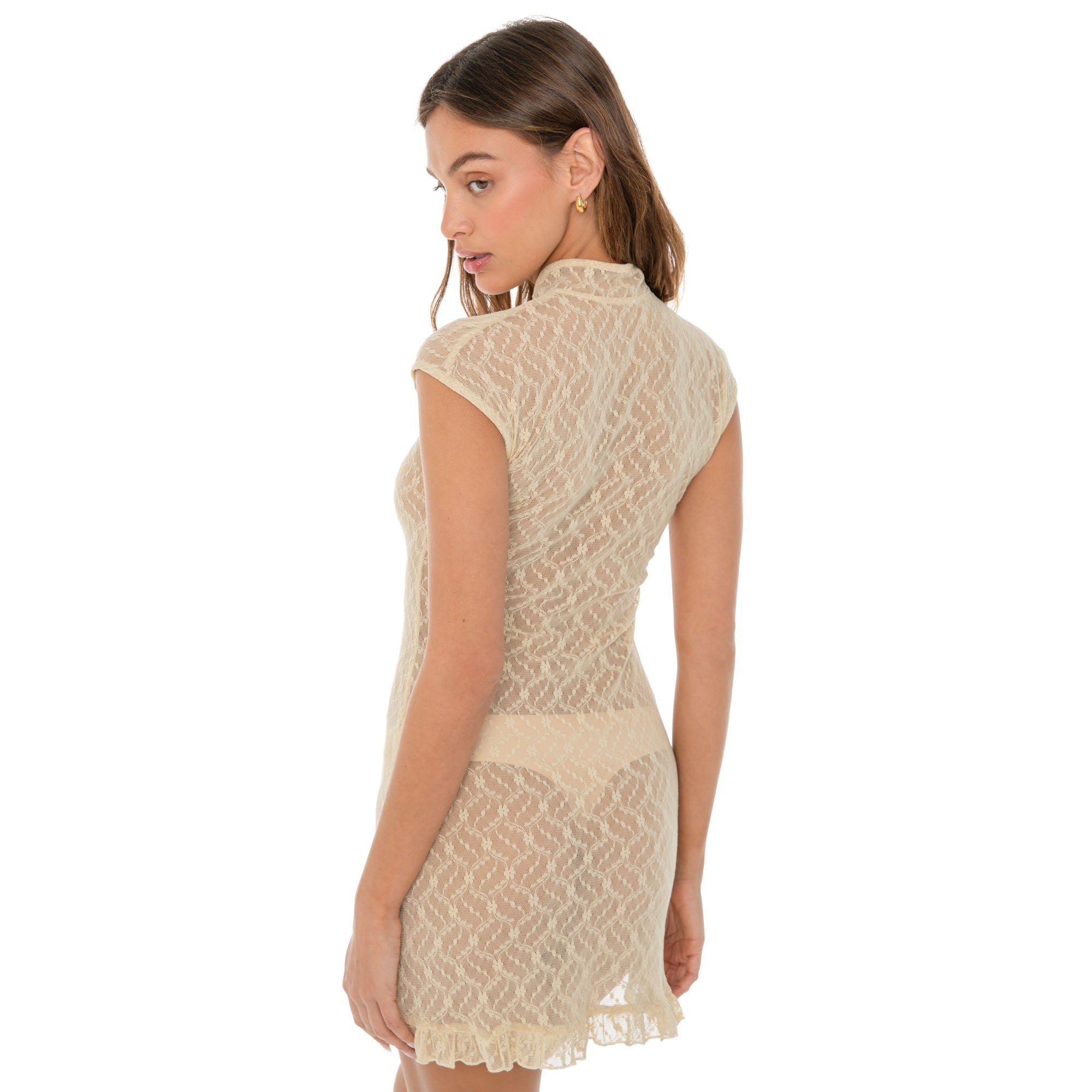 Back view of model in nude Bibi Dress showcasing sheer vintage lace and ruffled hemline. **nude