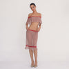 Model wearing the Cherry Blossom Liulu Skirt, moving and turning to show the low-rise fit, sheer floral lace, contrasting red lace trim, fitted silhouette, and movement of the ruffled hem **cherry blossom