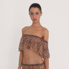 Video: Model wears the Liulu Leopard Top with a matching leopard print skirt, showing the top's off shoulder cropped fit, lace trimmed neckline, sheer leopard print fabric and flowing ruffle from multiple angles.
