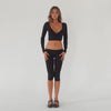 Video of model wearing the Clio Capri in black styled with the Nuka Top, showing stretch, movement, and fit through the leg **black