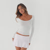 Video showing a model wearing a fitted off shoulder long sleeve silk top and mini skirt, highlighting the stretch, movement, and sculpted fit of the fabric in motion **white