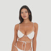 Video: Model wearing and moving in the ARE YOU AM I Iti Swim Top in cream, featuring ruched cups, thin straps, and wraparound ties **cream