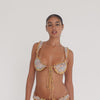 Model moves and turns while wearing the Nesi Swim Top in Paisley, showing the structured cups, ruffled shoulder straps, center-front ties, floral paisley print, and front and back fit **paisley
