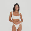 Video of model wearing the Nailah Swim Bottom in Cream, showing the fit and gathered detailing from multiple angles **cream