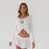 Model wearing white Lunet top and skirt set in motion showing fit, drape, and movement of ruffle hem and sleeves **white
