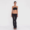 Model turns and poses in the Meili Pant in Black, showing the ultra low rise fit, wide ruched fold-over waistband, sheer fabric and subtly flared leg. **black