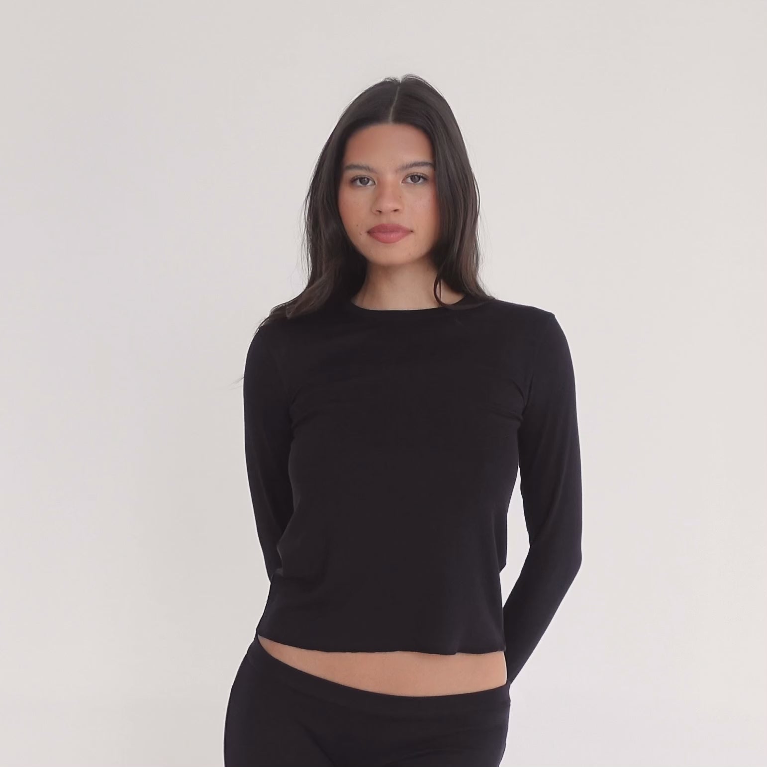 Video of model wearing the NIIMA Top in black, showing how the soft modal fabric moves and fits from multiple angles.**black