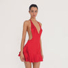 Video: Model turning to show the cherry red Atalanta Dress from multiple angles, highlighting its plunging V neckline, open back, halter ties and double ruffle hem **cherry red