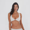 Styled view: Model wearing the sand Alue Top with matching bottoms, showing the twisted front and cropped fit **sand