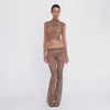 Video: Model turns and poses in the Liani Pant in Leopard, showing the sheer fabric, low rise lace waistband and flared leg from multiple angles