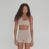 Video of Nove Short in nude capturing movement, foldover waistband, and sleek stretch fabric. **nude