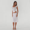 white ribbed midi skirt in motion with fitted tee, showcasing soft drape, subtle flare, and lightweight semi sheer texture **white