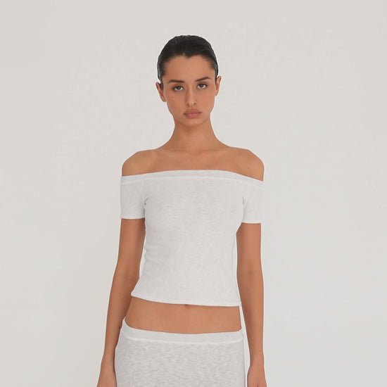 Video: Model wearing the white Solei off-the-shoulder top, showing the fit and garment details from multiple angles**white