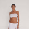 Video: Model wearing the Aili Tube in white, showing the fitted strapless silhouette and lightweight ribbed knit in motion **white