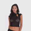 Model wearing the Bibi Top in black lace, featuring a high neckline with a self-tie detail and sheer floral lace **black