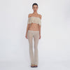 Video: Model turns and poses in the Liani Pant in Nude, showing the sheer floral lace, low rise waistband and flared silhouette from multiple angles. **nude