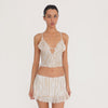 Video: Model wearing and moving in the Are You Am I Aria Skirt in Ivory Latte, showing the low-rise fit, zebra print, ruffled lace-trim hem and matching top. **ivory-latte