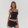 Video of model wearing black Nahla skort moving naturally, showing stretch, drape, and built-in shorts functionality **black