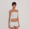 Video: Model wearing the Eran Bloomer in white, showing the low rise smocked waistband, relaxed bloomer silhouette, and ruffled leg openings from multiple angles.