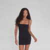 360-degree view of the Miia Dress in black, showing the fitted mini silhouette from all angles including the square neckline, thin straps, and seamless back fit on the model. **black
