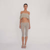 Model moves to show the cream sheer floral lace Lyli Capri and matching off shoulder top from multiple angles, highlighting the fit, length, and transparency of the lace. **sky blossom