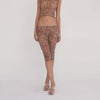 Model wearing the Lyli Capri in sheer brown leopard print, shown in motion to demonstrate the low rise fit, sheer fabric, and fitted cropped silhouette