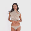 Model wearing the nude ARE YOU AM I Iselle Bottom with a matching lace top, moving and turning to show the sheer floral lace design and low-rise fit. **nude