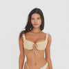 Close three-quarter front view of the latte Nou Swim Top, highlighting the wide straps, textured fabric, gathered cups, and adjustable center-front ties **latte