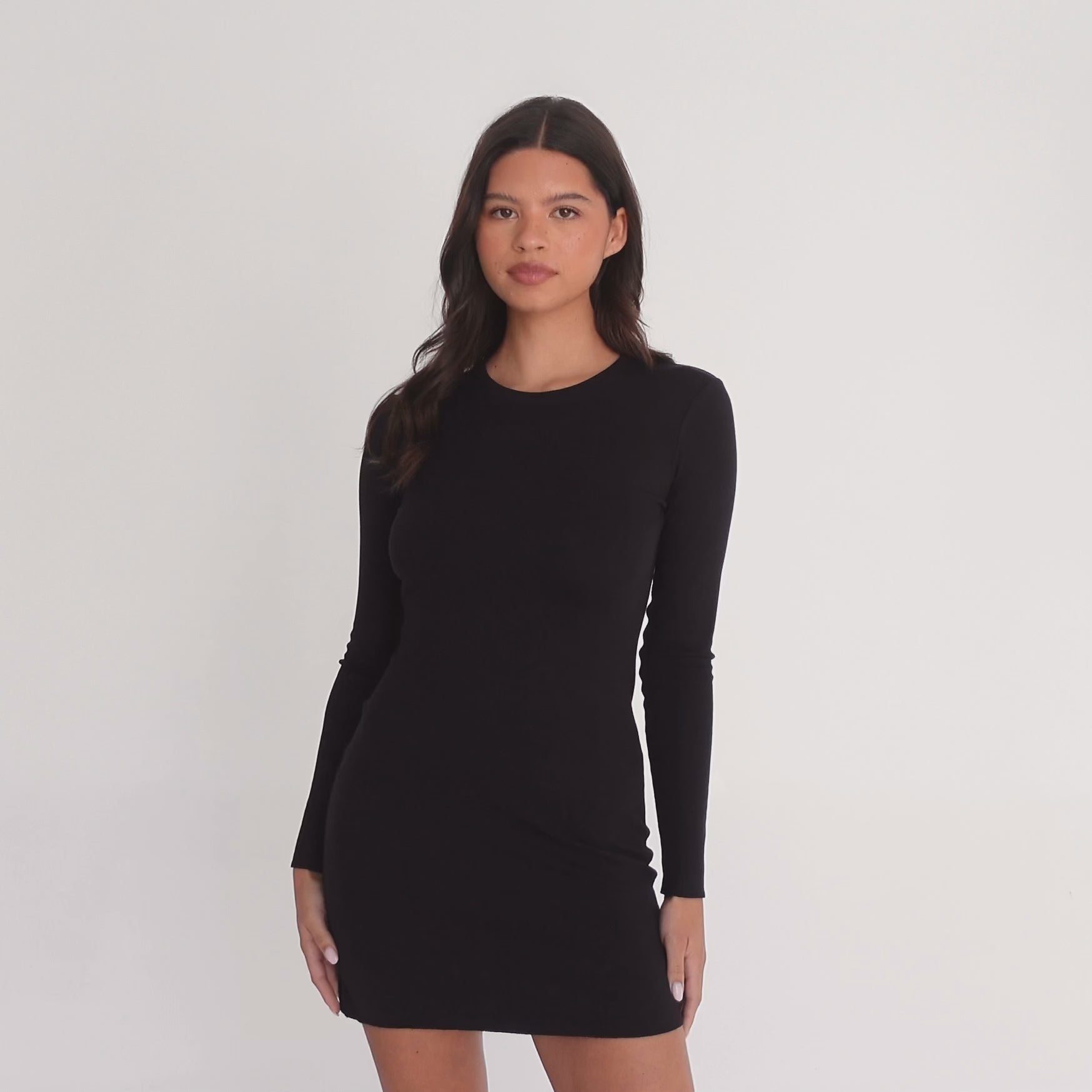 Model wearing the Niima Dress in black, showing front, side, and back views and how the soft modal fabric moves. **black