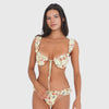 Video: Model moves and turns while wearing the Nesi Swim Bottom in Lemon Blossom with the matching top, showing the low-rise fit, ruffled waistband, floral print, and front, side, and back views **lemon blossom
