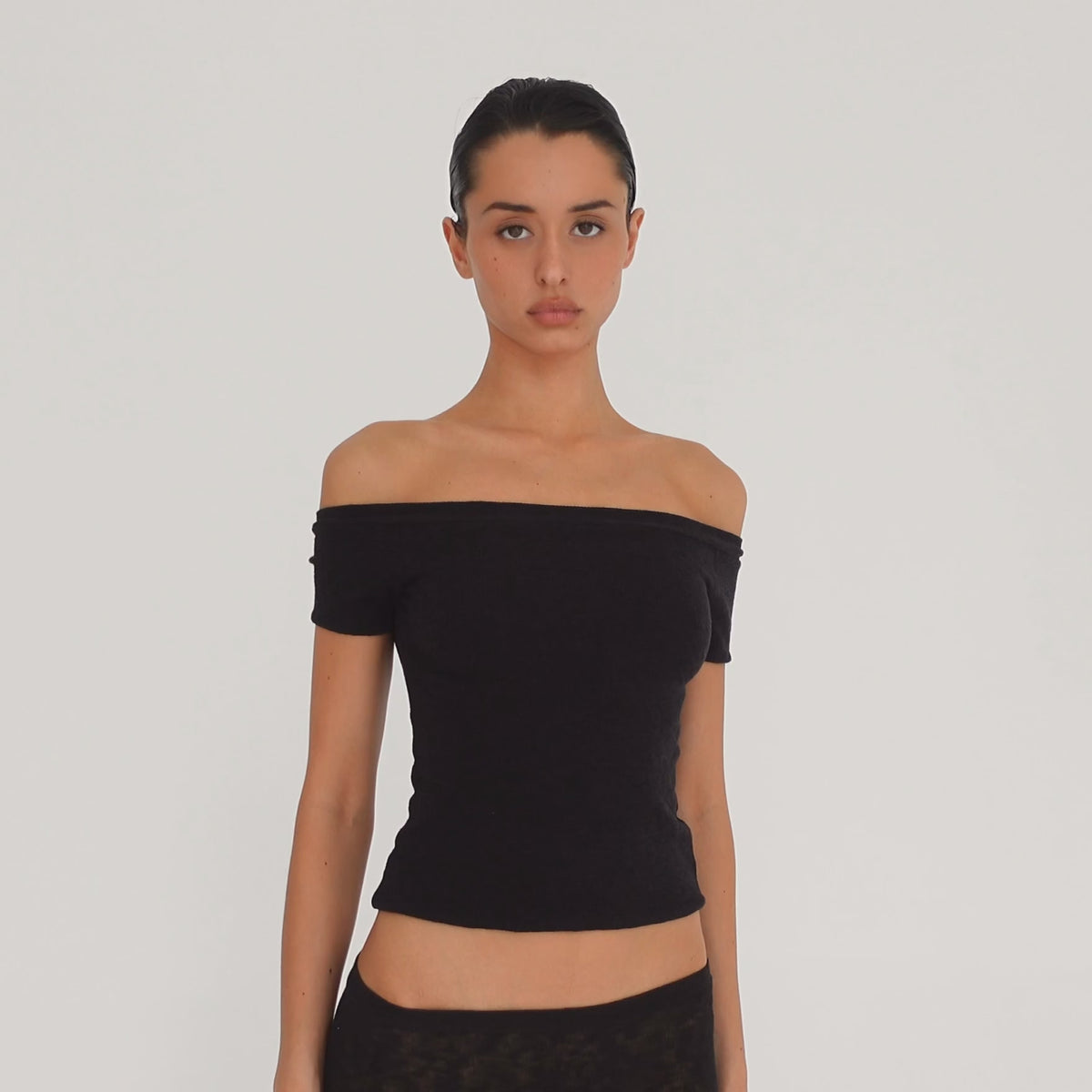 Video: Model wearing the black Solei off-the-shoulder top, showing the fit and garment details from multiple angles **black