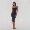Black midi dress in motion showing body-contouring fit, thin straps, and clean silhouette **black