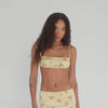Model showcases Are You Am I Missi Floral Bra in lemon silk charmeuse, a strappy micro top with delicate floral print and luxe summer-ready vibe. **lemon