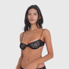 Model wears the sheer black floral lace Iselle Bra and moves through different angles to show the fit, transparent floral lace underwire cups, thin adjustable straps, center bow and back closure **black