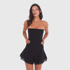 Video: Model wearing and moving in the Sunniva Dress in Black, a strapless corset mini dress with a fitted paneled bodice and sheer layered flared skirt **black