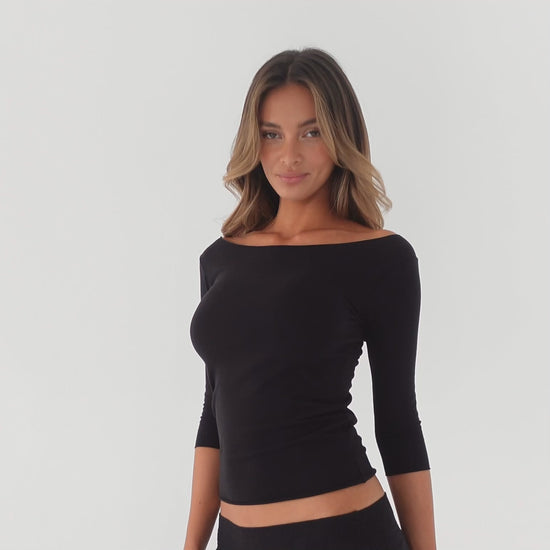360 video of off shoulder long sleeve top in motion showing stretch fit and minimal silhouette **black
