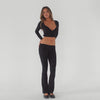 Video of model wearing the Clio Pant in black styled with the Nuka Top, showing movement and stretch of the fabric and flare **black