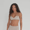 Video of Iida Bra in nude highlighting cross-back design, double straps, and flexible fit. **nude