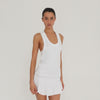 Video: Model wearing the white Suki Dress, showing the fit, movement, racerback and flounced drop-waist skirt from multiple angles. **white