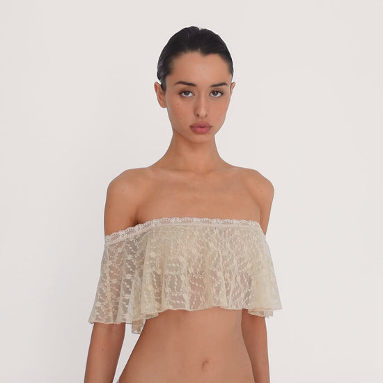 video: Model wearing the Liulu Top in nude, showing the movement, sheer floral lace and off shoulder ruffle silhouette from multiple angles **nude