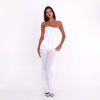 Back three-quarter view of the Sunniva Pant in White, highlighting the fitted low-rise silhouette and flared hem **white