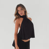 Video of model wearing black halter scarf top showing movement and drape from multiple angles **black